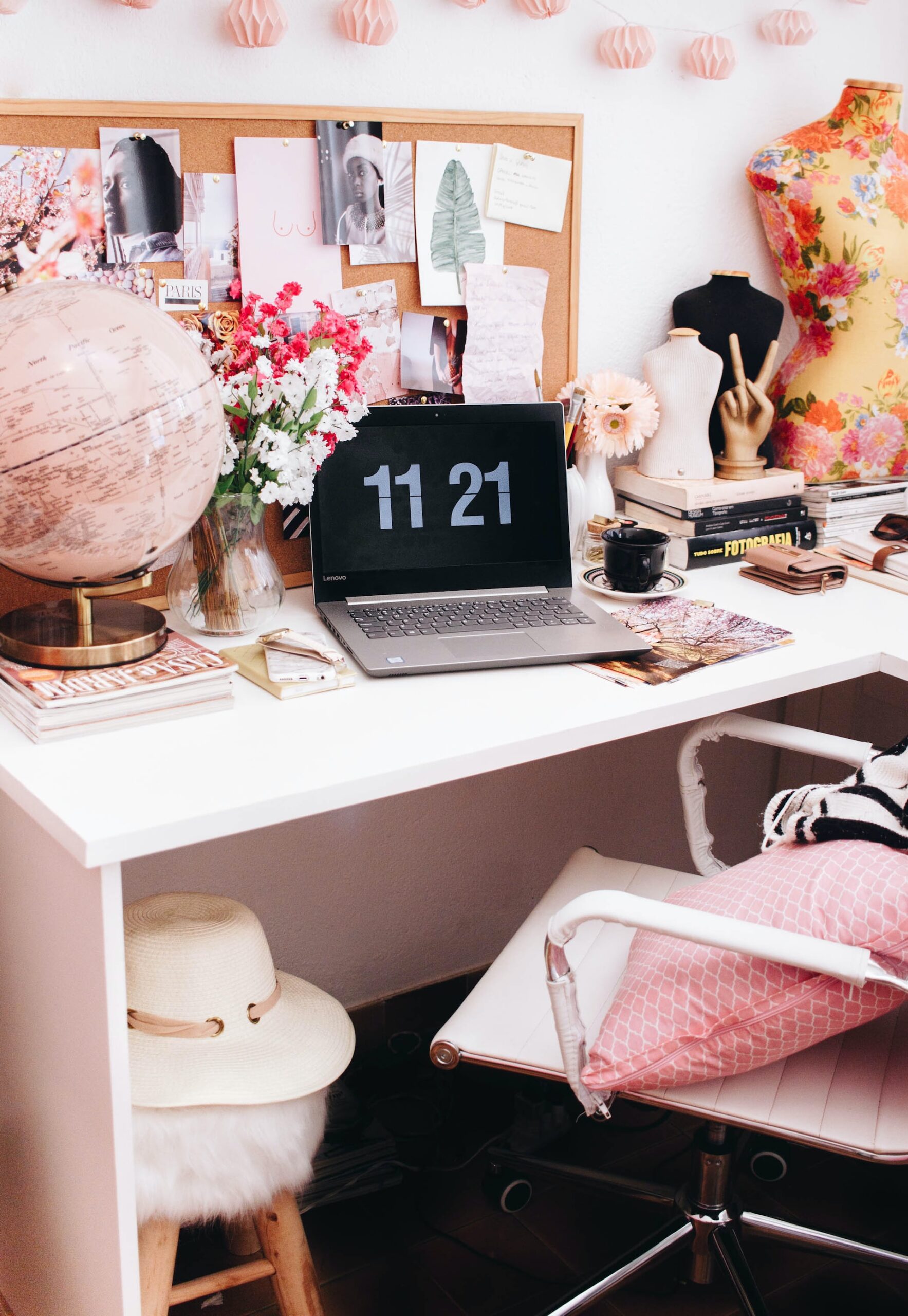 laptop with time on a pretty pink and white desk 