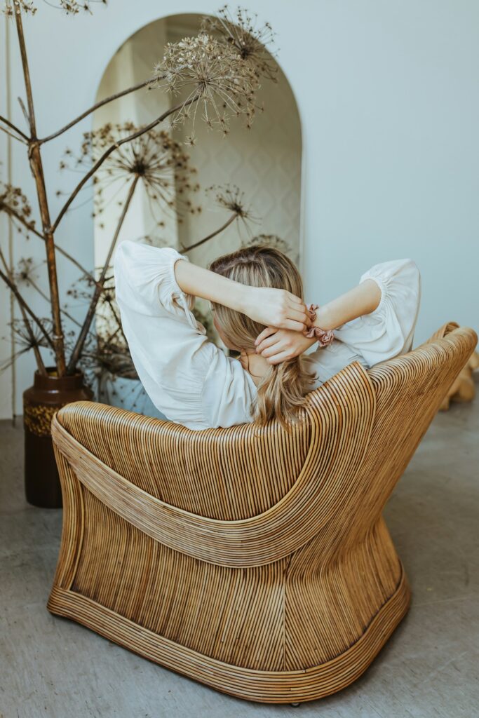 woman sitting in hair. you can see her from behind.