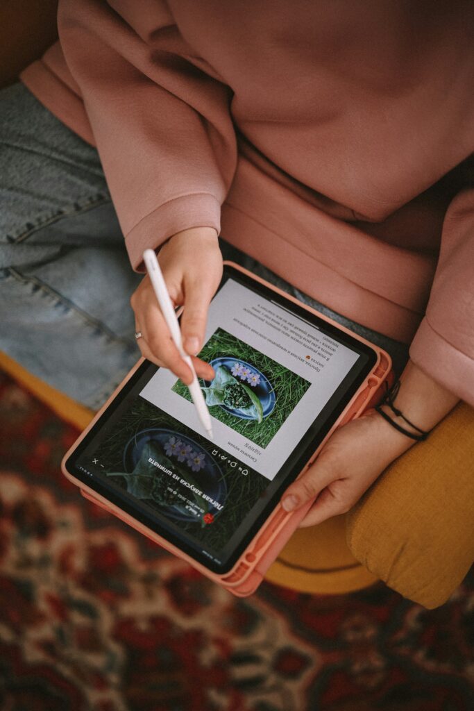 woman writing on tablet